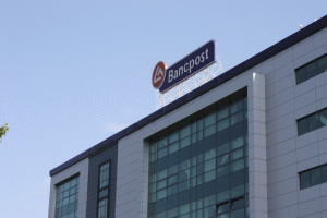 Profitul net al Bancpost a scăzut cu peste 50%
