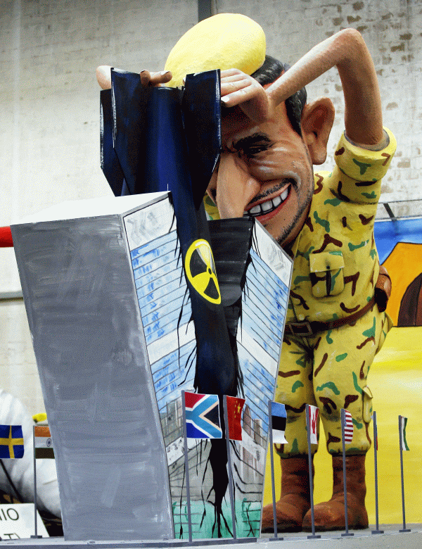 A character represents Iranian president Mahmoud Ahmadinejad destroying the headquarters of the United Nations with an atomic bomb, during the final preparations for a carnival which is taking place this week in Köln, Germany.